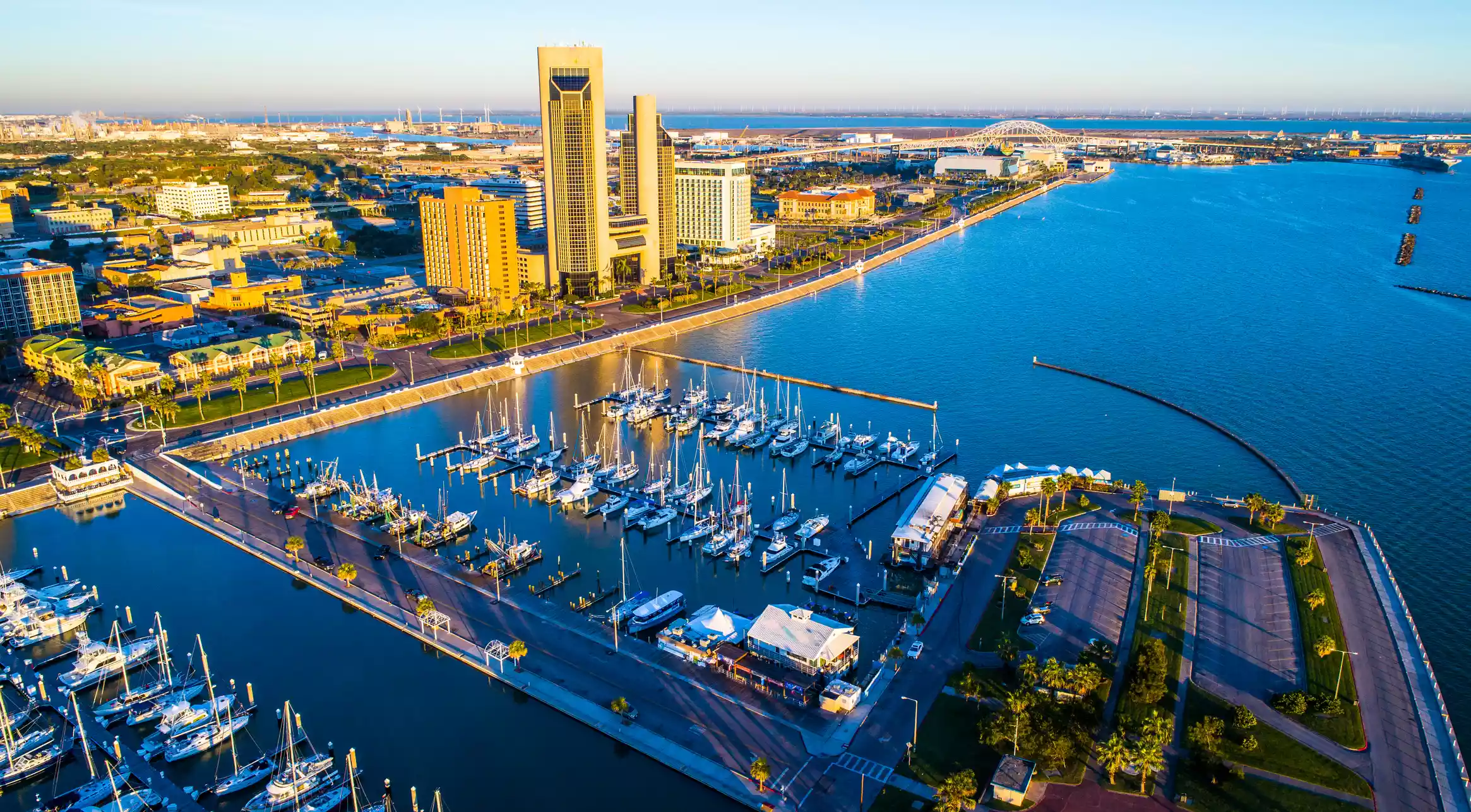 Aerial Drone View Corpus Christi , TX Bayfront at sunrise long shadows behind the Twin Towers and Harbor Bridge with T-Head